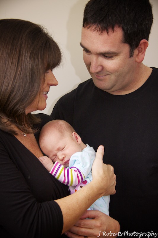 baby with adoring parents - newborn portrait photography